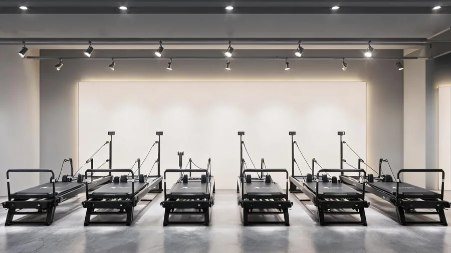 C26 commercial pilates reformers displayed in a row at a bright Guangzhou showroom