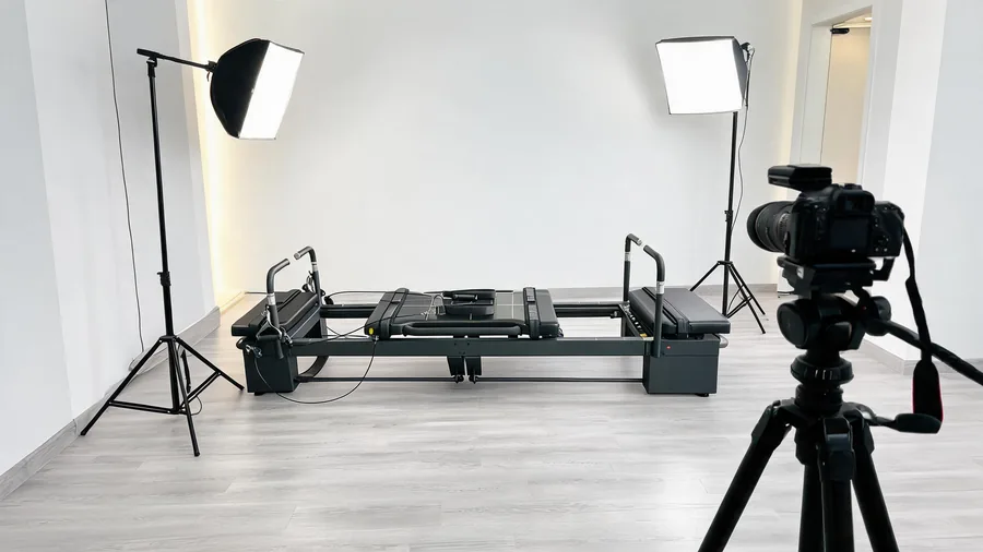 K30 commercial reformer in a pilates studio set up for YouTube filming with camera and lighting