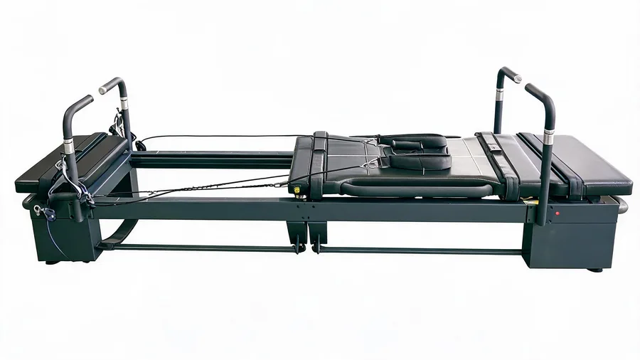 Pilates reformer for weight loss: science, workouts, and studio integration 1 Reformer carriage in motion along the rail with springs extended