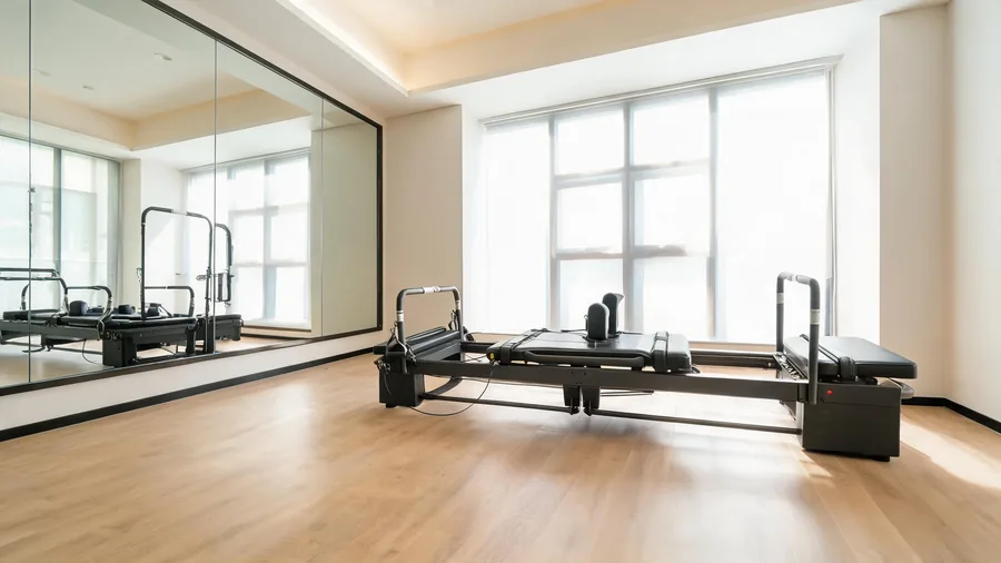 Pilates reformer headrest guide cover with K30 reformer in a bright studio